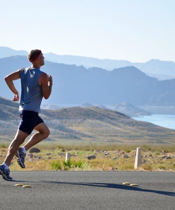 man running on side of road