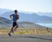 man running on side of road