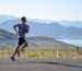 man running on side of road