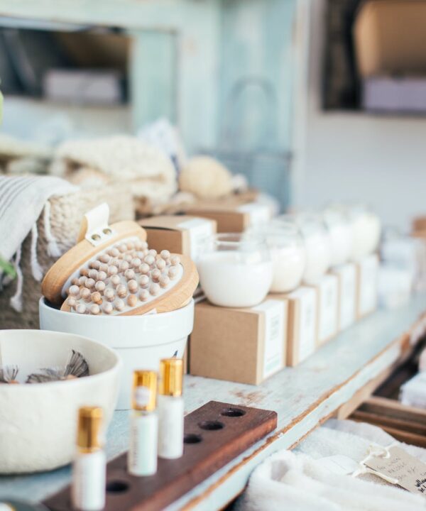 perfume placed near bath brushes and aromatic candles